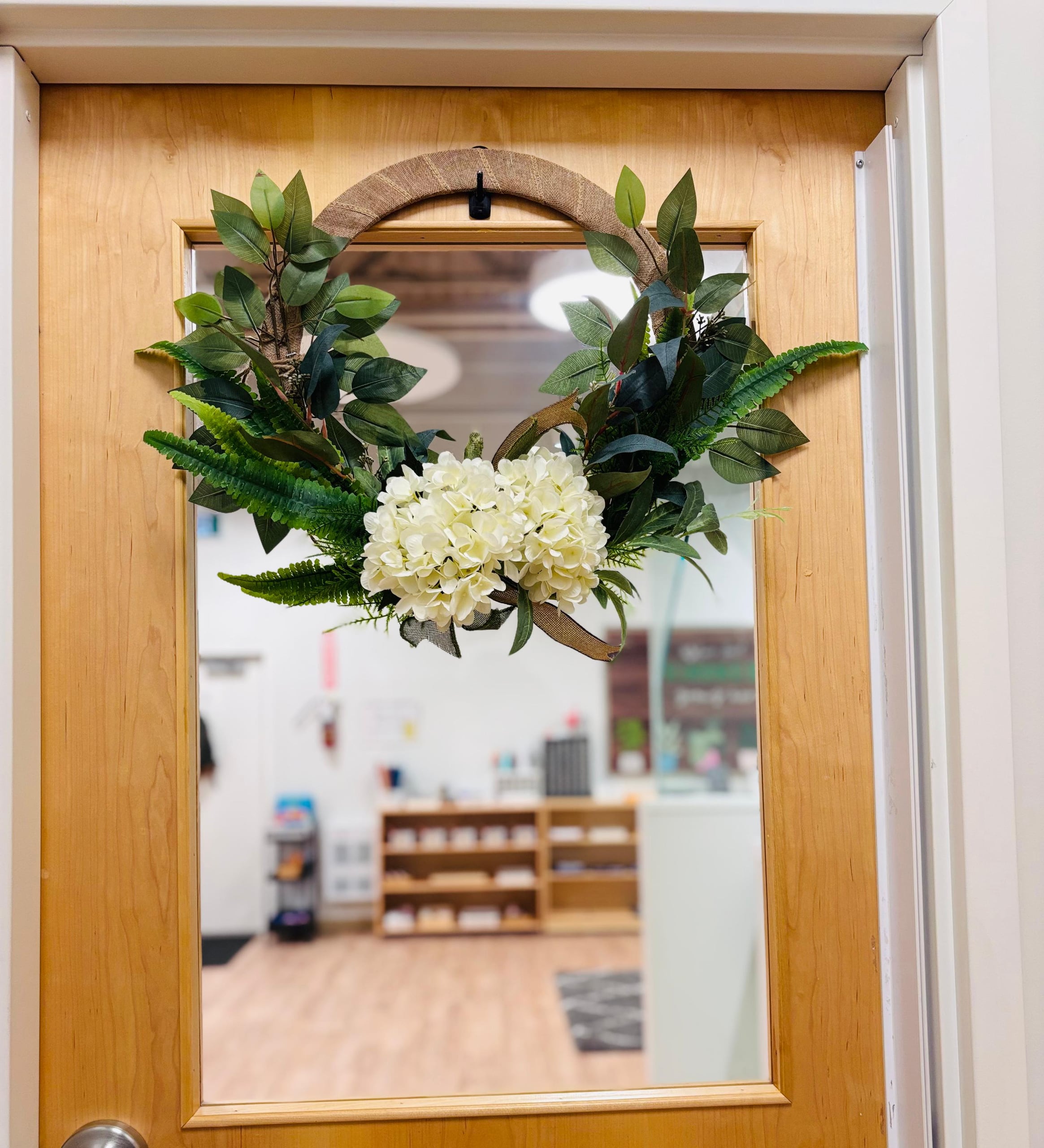 A welcoming door, dressed in greenery
